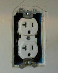A duplex receptacle with the cover removed