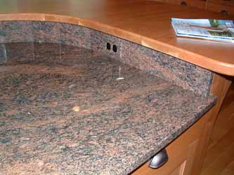 An installed granite electrical outlet cover