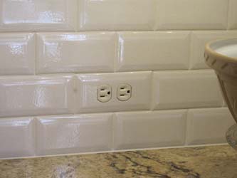 Close up of a tiled in subway tile switch plate cover